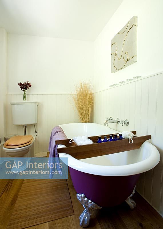 Country bathroom with purple roll top bath