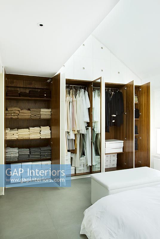 wardrobe showing Tanya Laurie's latest collection of clothing in modern white bedroom