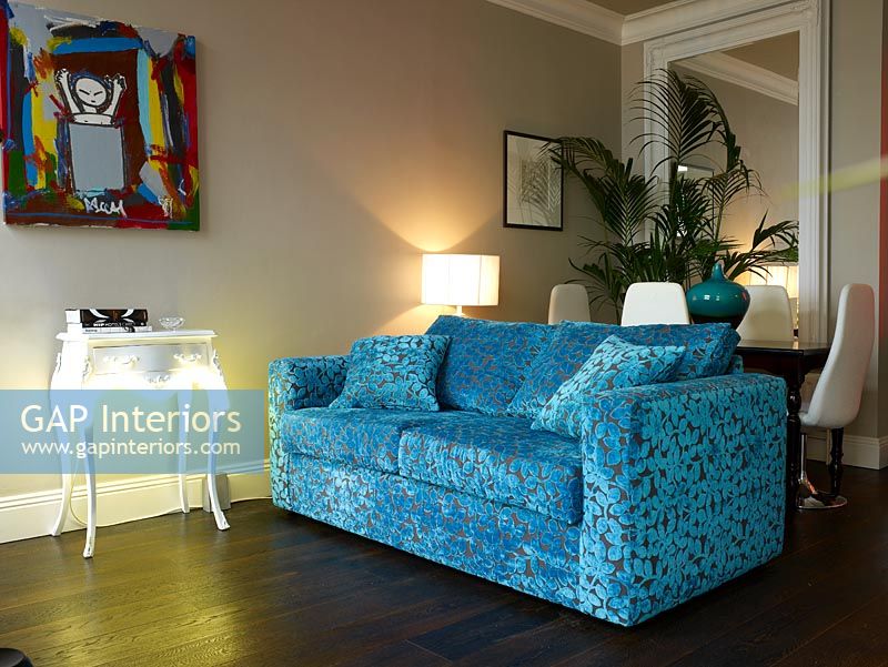 Modern living room with blue pattern fabric sofa and ambient lighting