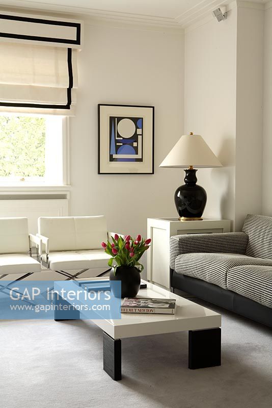 Modern living room with white armchairs, grey sofa and coffee table