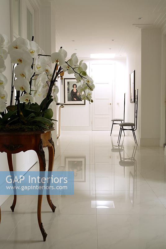 Classic white hallway wit console table and marble floor