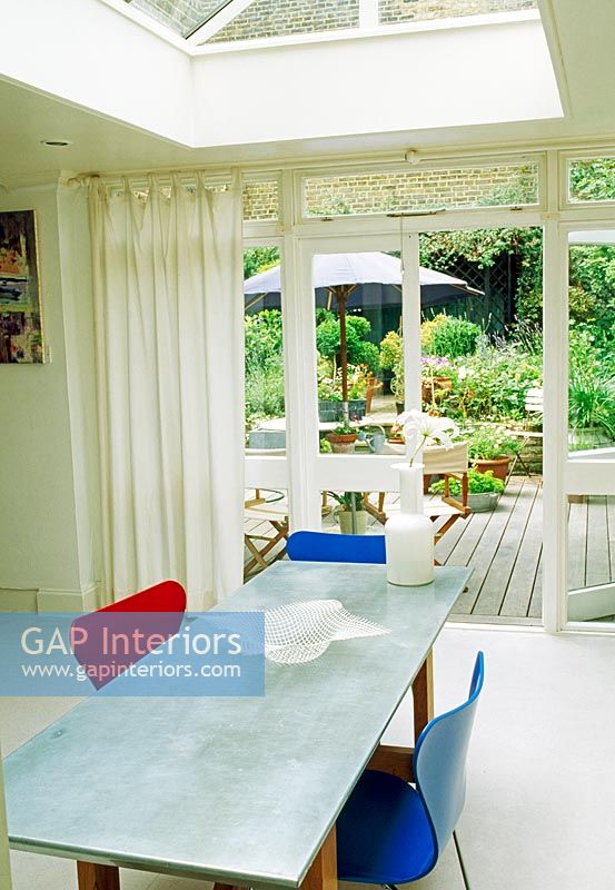 Modern dining room with view through patio doors to rear garden