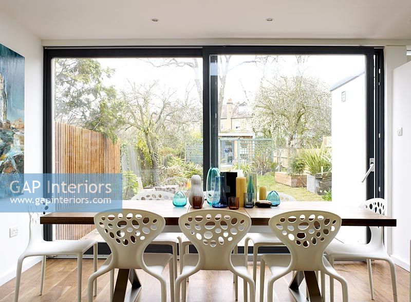 Modern dining room with  patio doors and view to garden