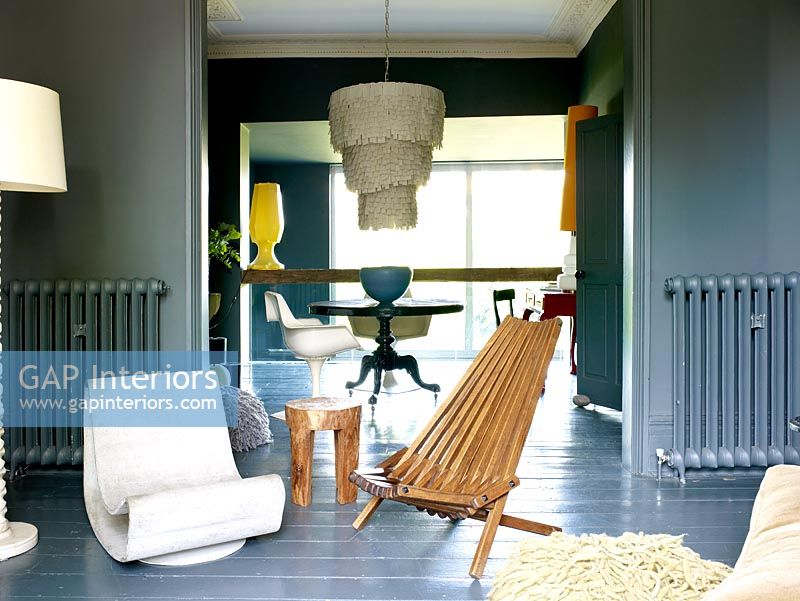 Open plan grey living and dining room with painted walls and floorboards 