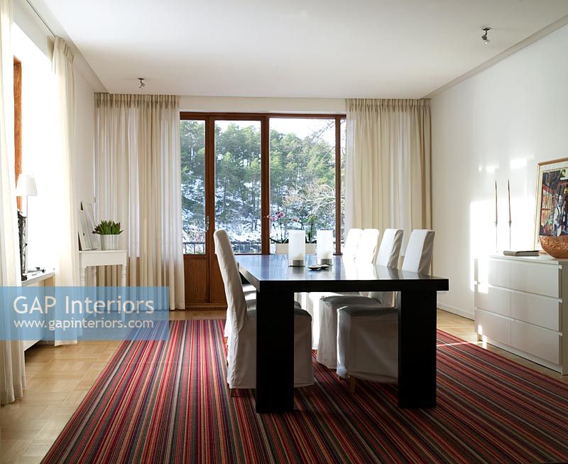 Modern dining room with stripy rug
