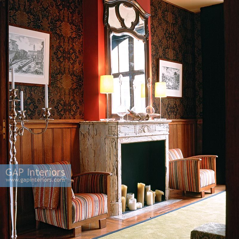 View of fireplace with armchairs either side