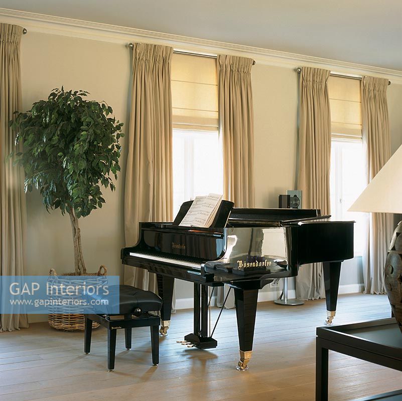 Grand piano with music in room