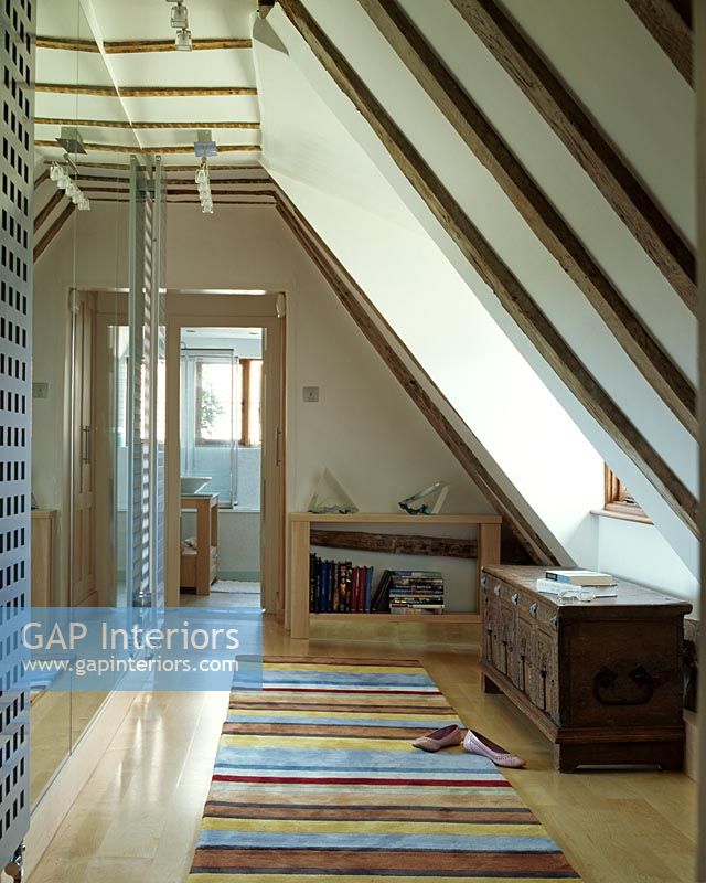 Loft with striped rug on laminate flooring