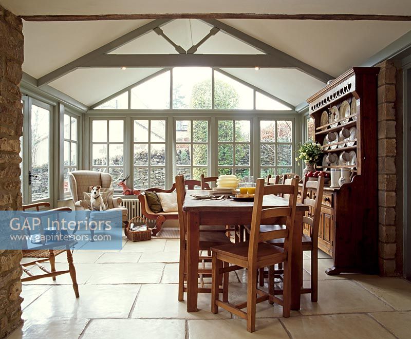 Large dining room with dog on armchair