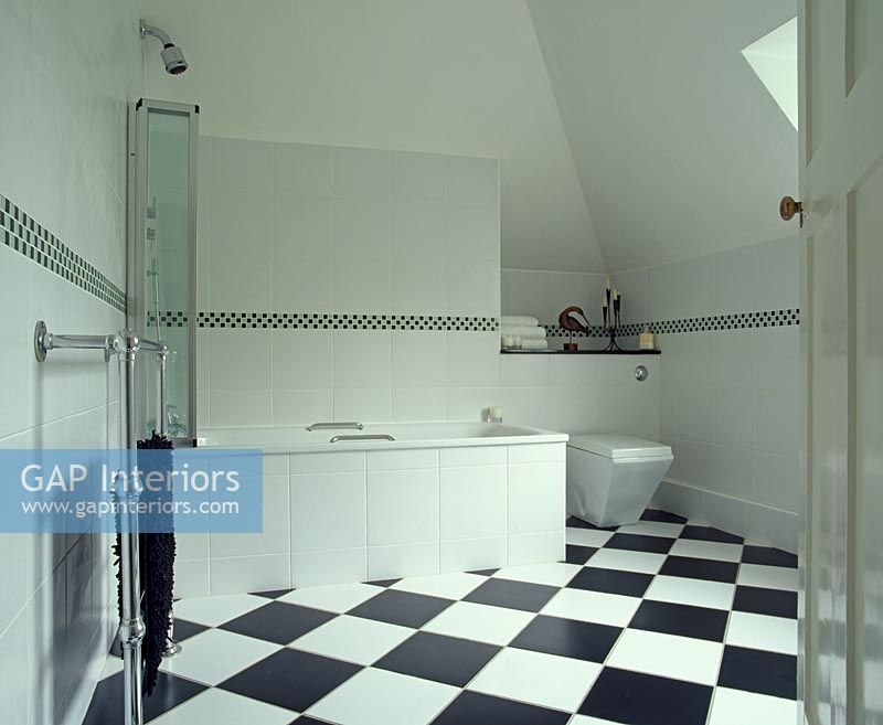 Bathroom with bath and checked tile floor