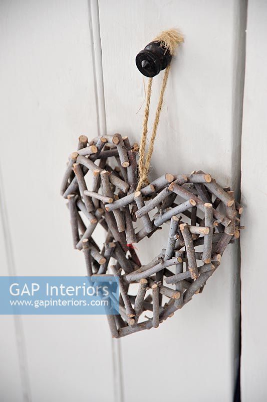 Wooden heart hanging on door handle 
