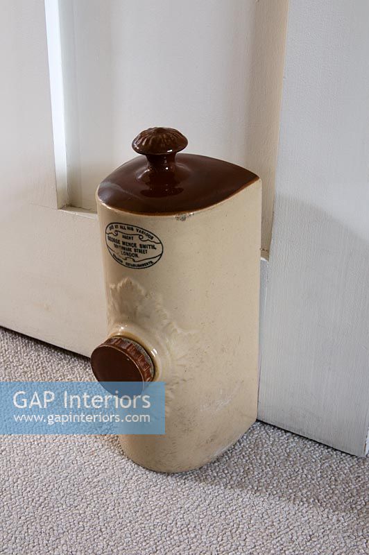 Victorian hot water bottle used as doorstop