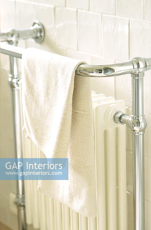Close-up of a bathroom radiator and towel drying rack