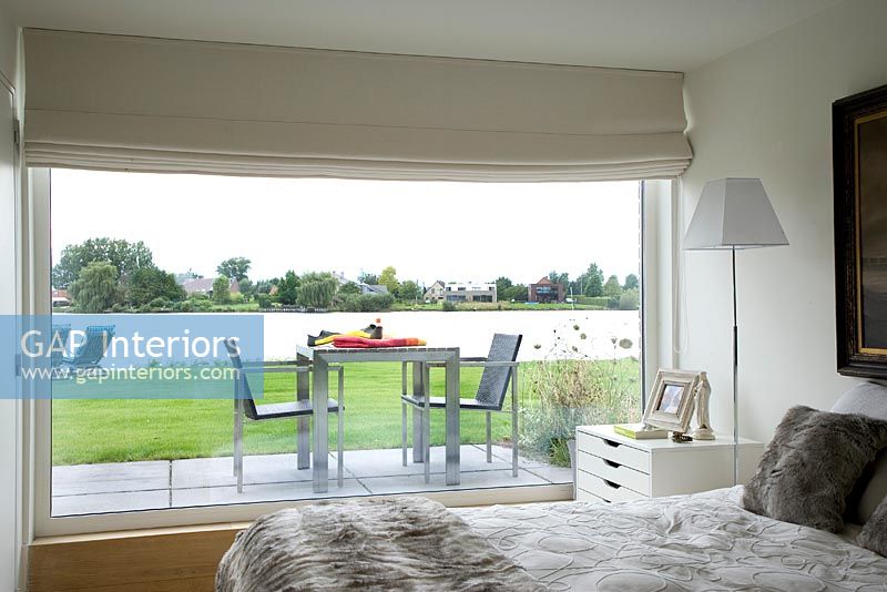 Modern bedroom with picture window to terrace