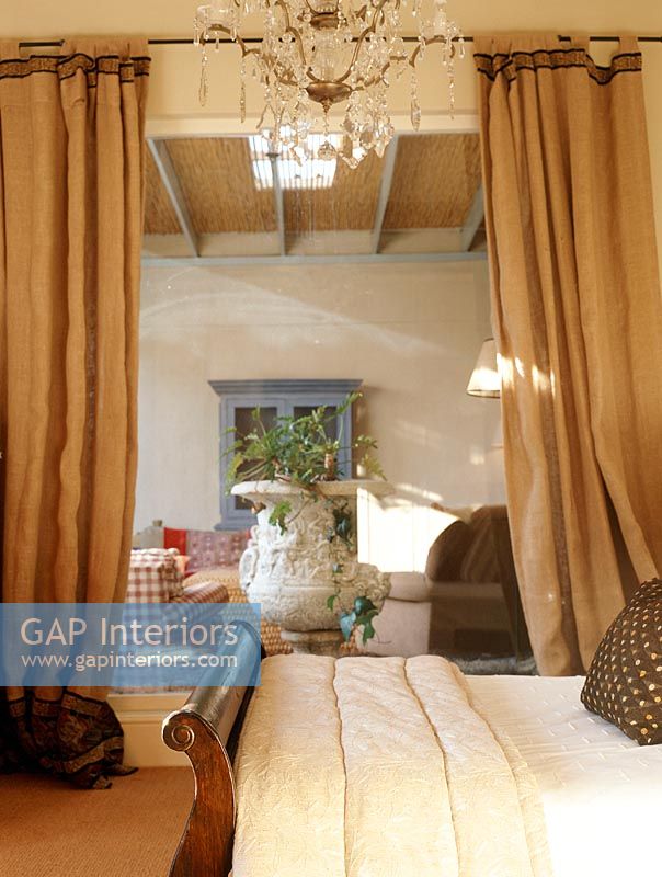 Bedroom with curtains and chandelier