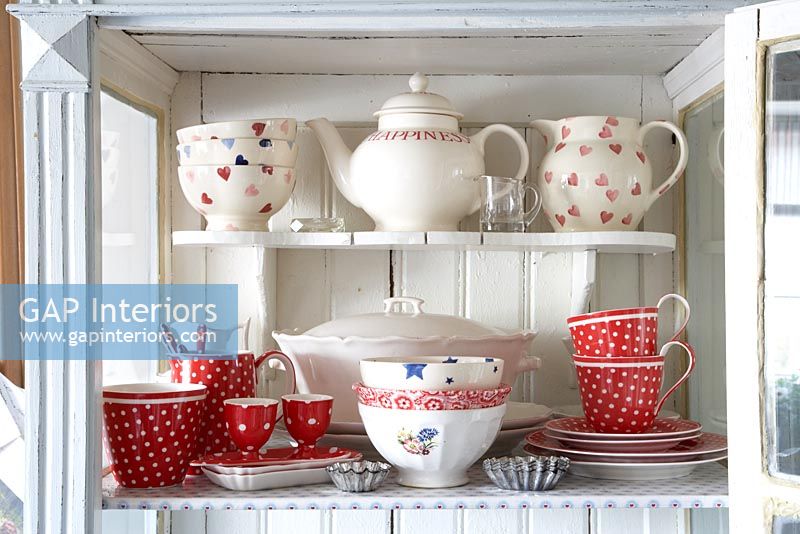 Collection of crockery in cabinet