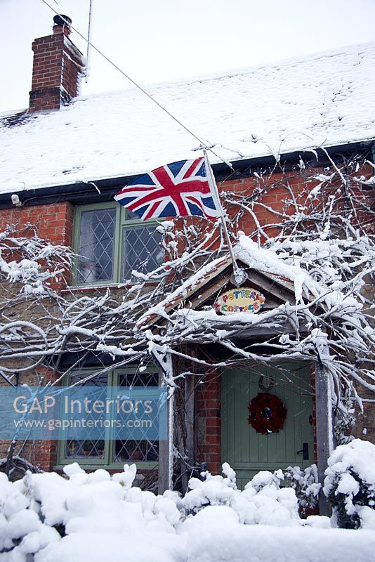 Country cottage exterior in the snow 