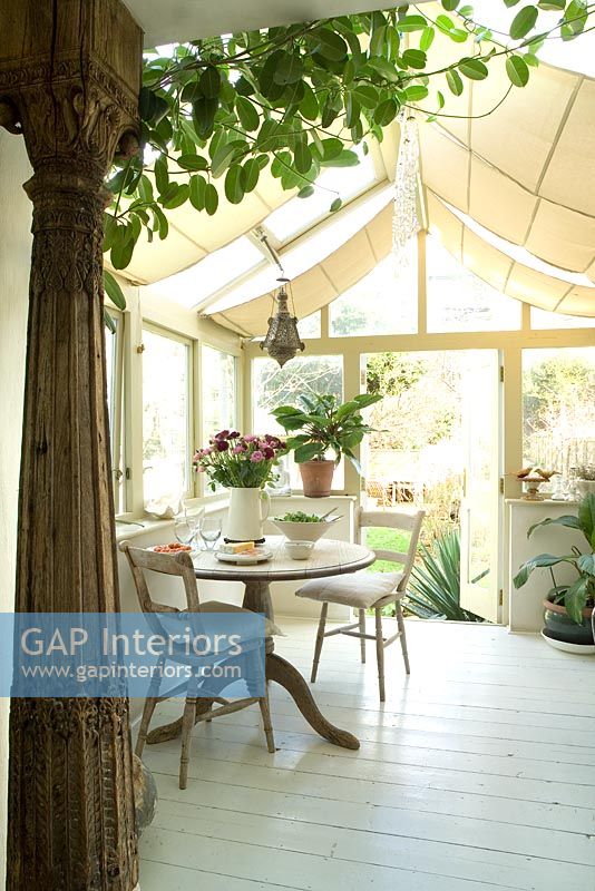 Table and chairs in modern conservatory 