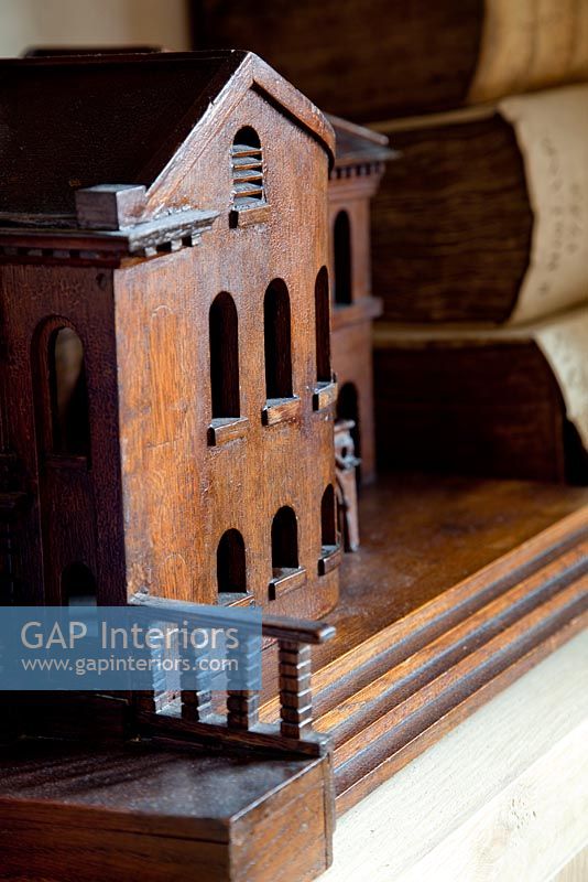 Carved wooden miniature house on shelf