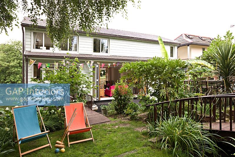 Modern houseboat exterior with garden