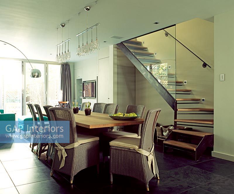 Modern dining room next to staircase 