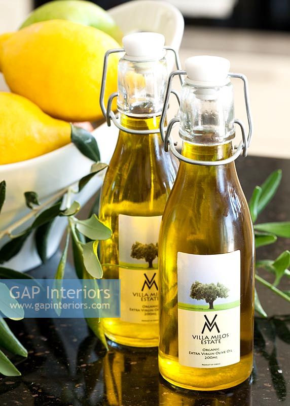 Bottles of olive oil on worktop, detail