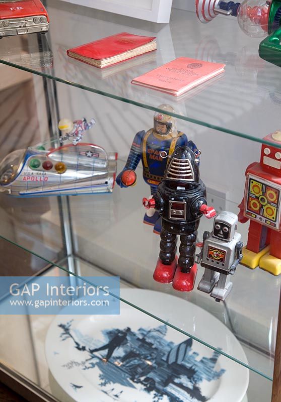 Vintage toys in glass display cabinet 
