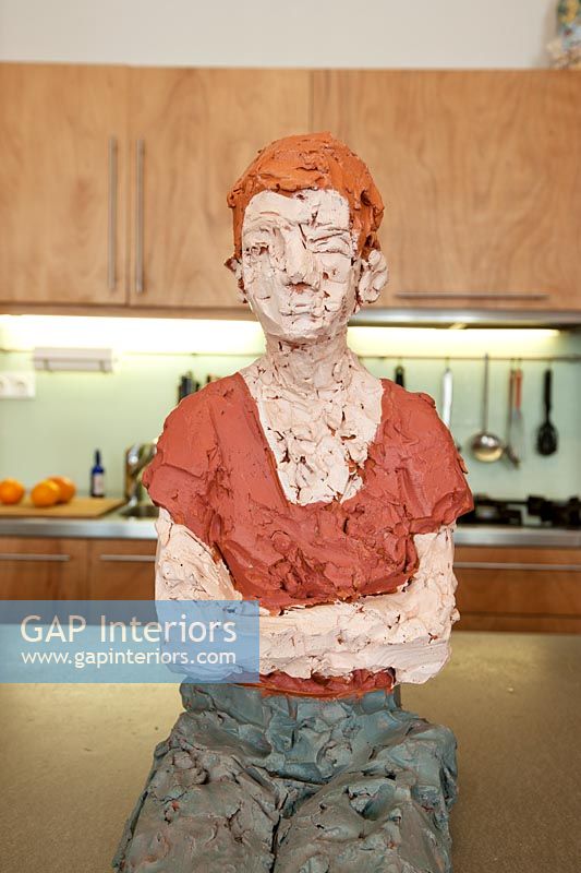 Painted clay figure in kitchen