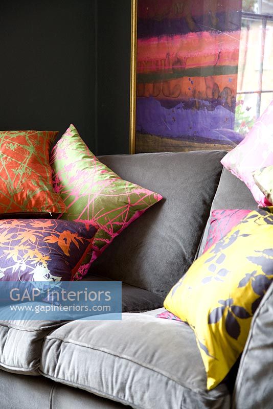 Colourful cushions on grey sofa