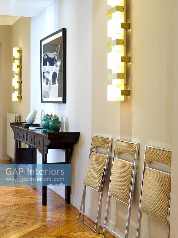 Console table and wall lights in hallway 