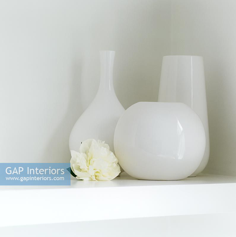 White glass vases on shelf