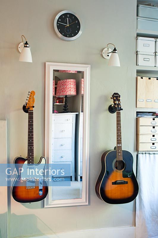 Two wall mounted guitars 