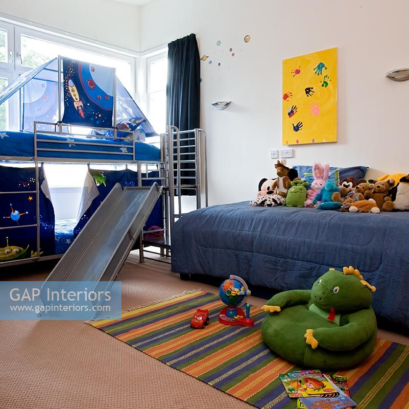 Modern childrens room with slide from the bed