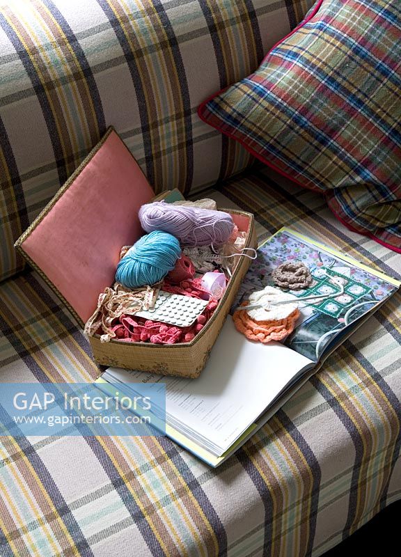 Needlework box on tartan sofa