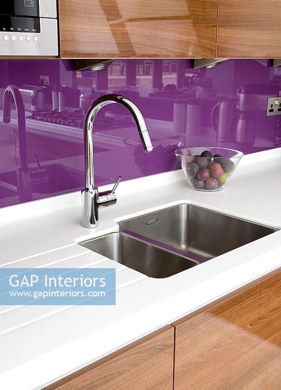 Modern kitchen sink with purple splash backs 