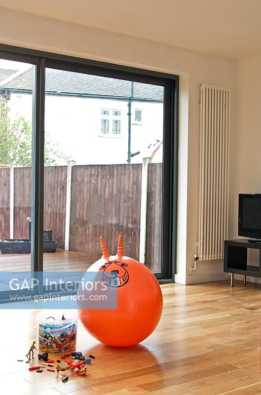 Space hopper and toys on wooden floor 