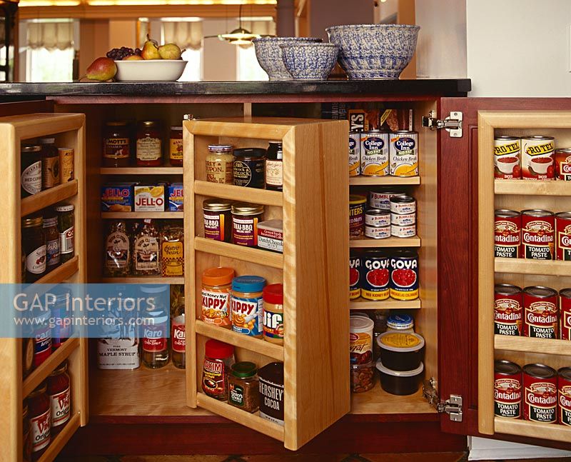 Detail of folding storage cupboards in kitchen