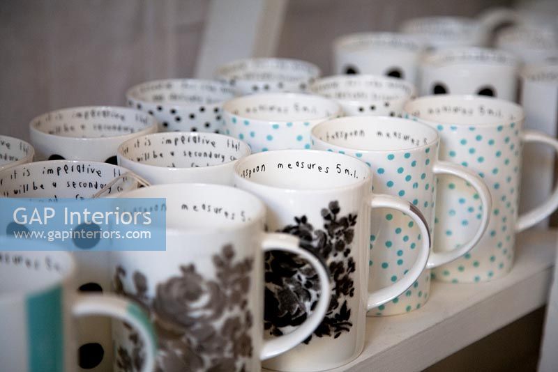 Collection of mugs on shop shelf 