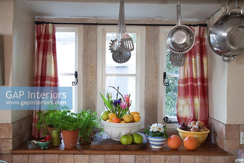 Food and utensils on kitchen windowsill 