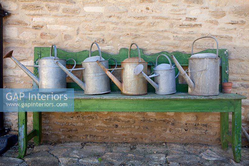 Display of vintage watering cans 
