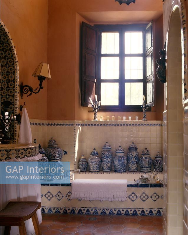 Collection of ceramic pots in eclectic bathroom