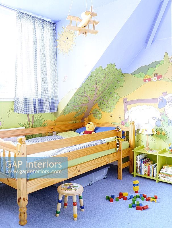 Childrens room with colourful wall murals 