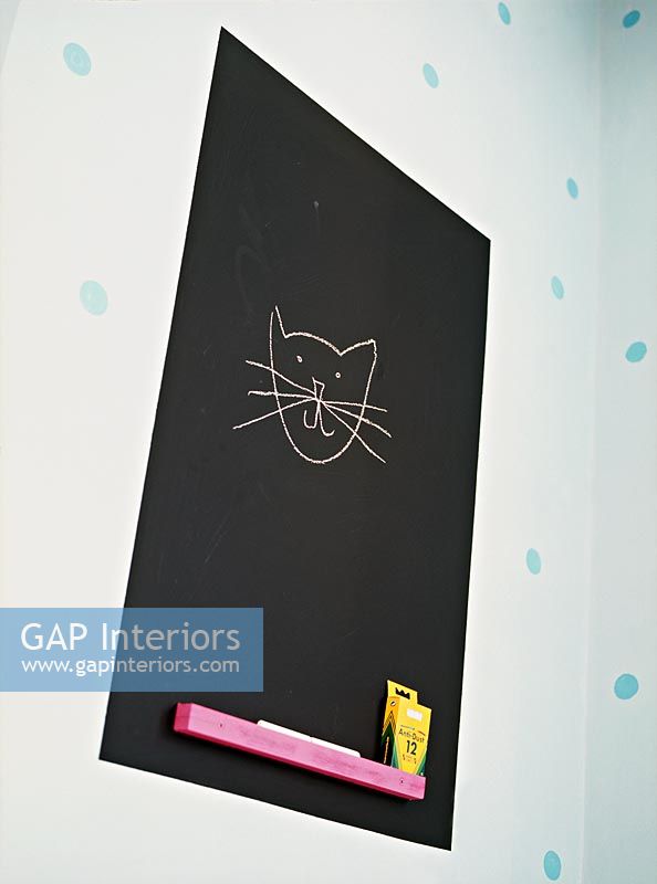 Cat drawn on blackboard in childrens room 