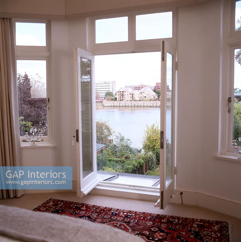 Open french windows with river views 