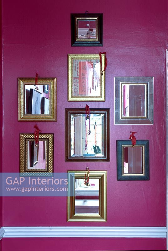 Display of mirrors on colourful wall 