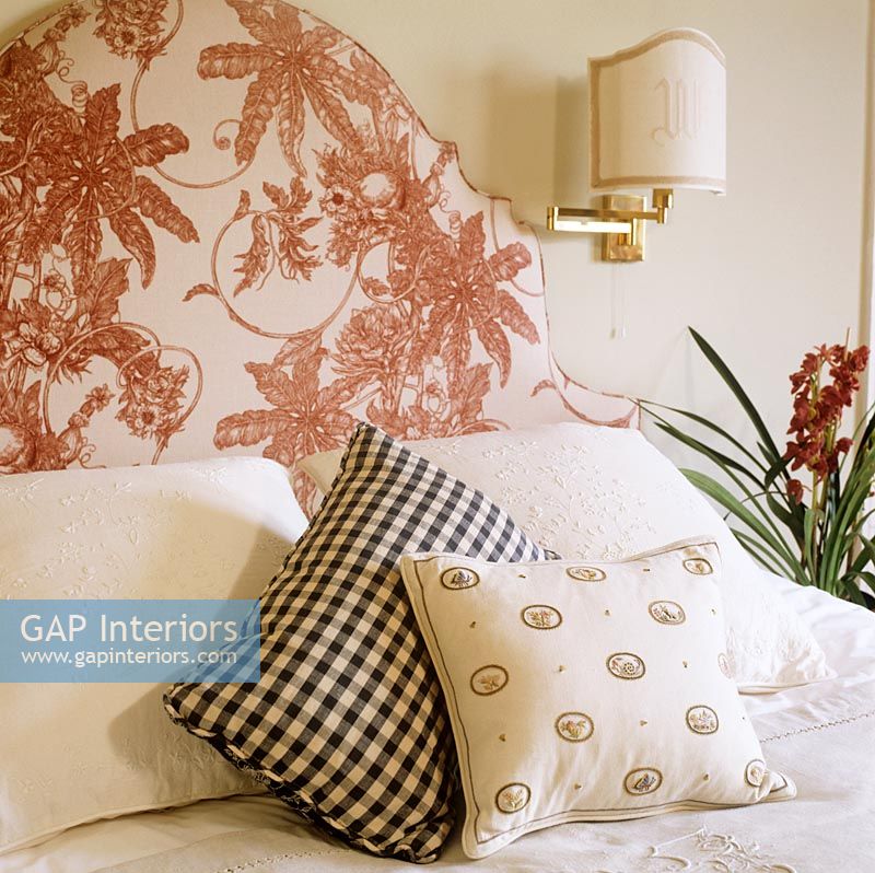 Patterned pillows on classic bed 