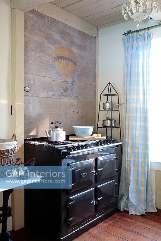 Aga in country kitchen with decorative wall 