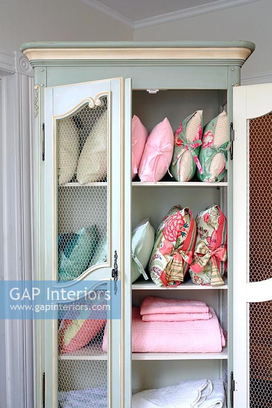 Vintage cabinet full of cushions and fabrics 