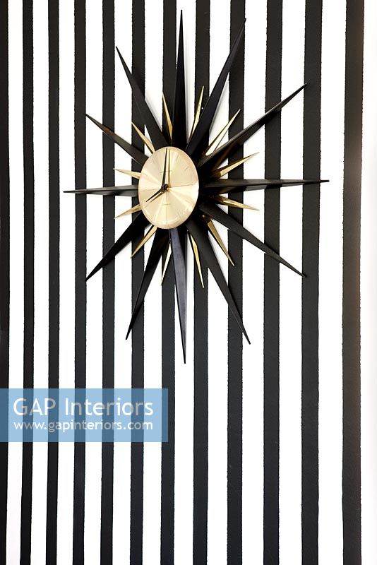 Clock and stripy wallpaper