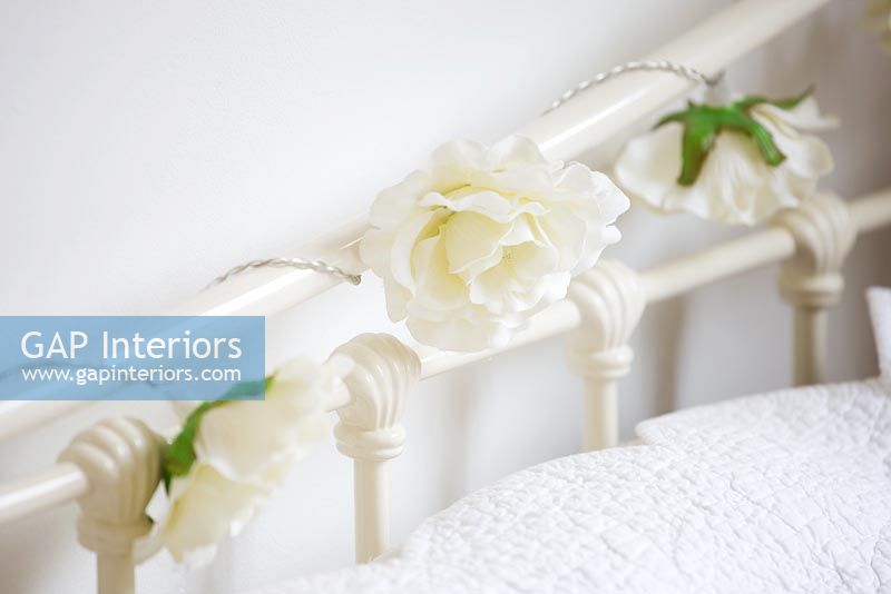 Fake Roses wound around bedstead